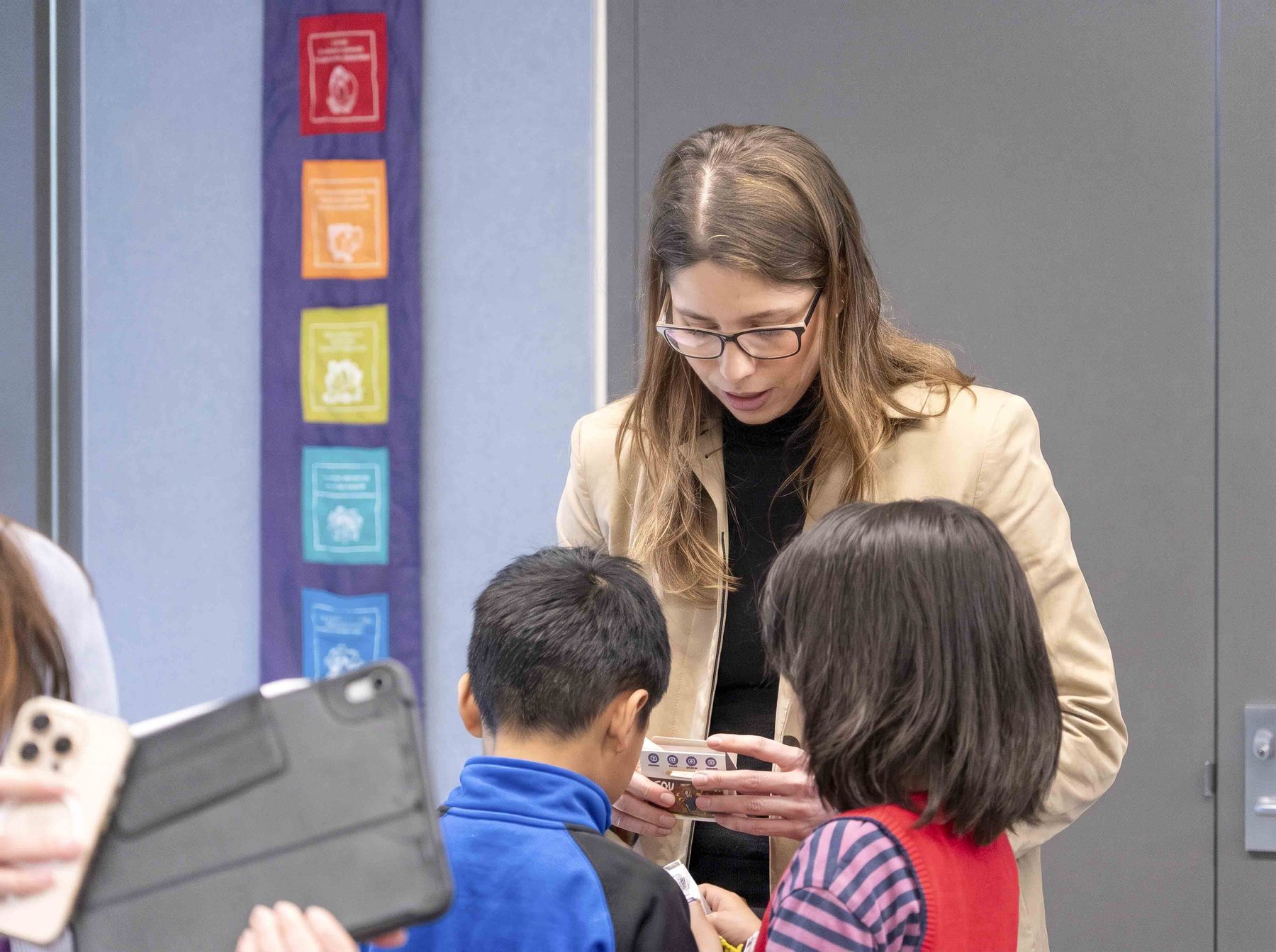 A facilitator helping a child with a building activity