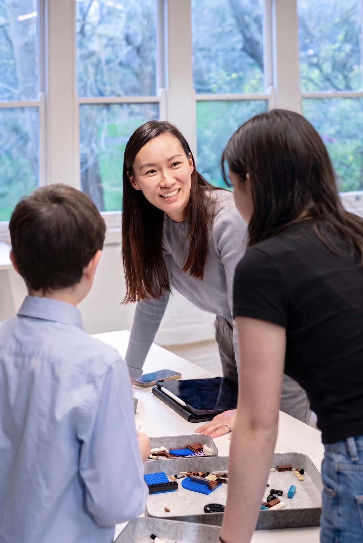 The psychologist sitting with a small group of children
